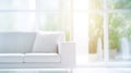 Abstract blur of a white sofa in a sun-drenched modern living room.