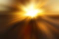 Abstract blurred golden background with a flash and diverging rays in the middle