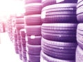 Abstract blurred background with car tires for sale. Blur photo of lots of car tires in the shop for sale. Car parts store bokeh b Royalty Free Stock Photo