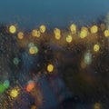 Abstract blurred background of the city night lights rain. Wet window with rain drops, street bokeh. Concept of weather Royalty Free Stock Photo