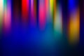 Abstract blurred background multicolored light rays elongated vertically