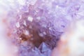 Abstract blurred background with shiny purple amethyst crystal geode