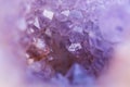 Abstract blurred background with shiny purple amethyst crystal geode