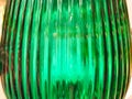 Abstract blurred background shot through thick green glass with shiny rays. Fuzzy colorful backdrop. Glass bottle Royalty Free Stock Photo