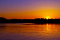 Abstract blurred background with summer lake landscape with golden sunrise. River landscape. Beautiful blur bokeh lights landscape