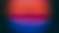 Abstract blurred colored background red, blue, orange in a dark frame