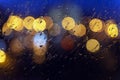 Abstract blurred colorful background. Wet window in rainy weather, bright bokeh, neon city lights Royalty Free Stock Photo