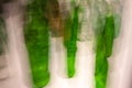 Abstract blurred colorful light effect on a glass bottles. Long exposure photo of moving camera