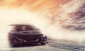Abstract blurred drift car with smoke from burned tire at sunset Royalty Free Stock Photo