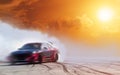 Abstract blurred drift car with smoke from burned tire at sunset