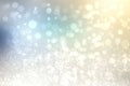 Abstract blurred festive winter christmas background with shiny blue and yellow white bokeh lighted snow landscape with stars and Royalty Free Stock Photo