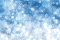 Abstract blurred festive winter christmas or Happy New Year background with shiny blue and white bokeh lighted snow landscape. Royalty Free Stock Photo