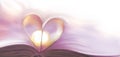 Abstract blurred heart background from book pages with lilac accent Royalty Free Stock Photo