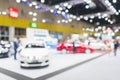 Abstract blurred image of cars exhibition show. Blurred defocused image of public event exhibition hall showing cars and Royalty Free Stock Photo