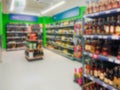 Abstract blurred image. Defocused lens. Wine, cognac and other alcoholic beverages on the shelves in the supermarket Royalty Free Stock Photo