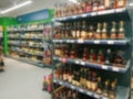 Abstract blurred image. Defocused lens. Wine, cognac and other alcoholic beverages on the shelves in the supermarket Royalty Free Stock Photo