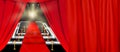 Abstract blurred image. Red carpet with stairs between two rope barriers and flash light. Scene illuminated by a spotlight. Royalty Free Stock Photo