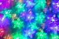 Abstract blurred luminous background of bright star-shaped neon lights.