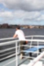 Abstract blurred man leaning on boat ferry railings Royalty Free Stock Photo