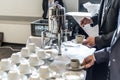 Abstract blurred many rows of coffee tea cups with coffee dispenser business people taking one