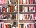 Abstract blurred modern white bookshelves with books. Blur manuals and textbooks on bookshelves in library or in book store. Royalty Free Stock Photo