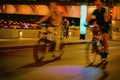 Abstract blurred night city lights and cyclists silhouettes