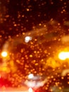 Abstract blurred photo of bokeh from rain drops on the window and light on road at rainy night Royalty Free Stock Photo