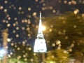 Abstract blurred photo of pagoda and bokeh from rain drops on the window at rainy night Royalty Free Stock Photo