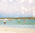 Abstract blurred photo of people at the beach, image is blurred ready for typography