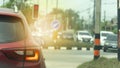 Abstract and blurred rear side of red car stop by traffic red light control. Royalty Free Stock Photo