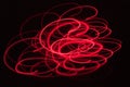 Abstract blurred red light effect on a black background. Long exposure photo of moving camera