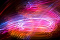 Abstract blurred space comet, multi-colored light lines on a black background