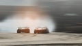 Abstract blurred two drift cars battle with smoke from burned tire Royalty Free Stock Photo