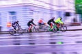 Abstract sport blurred violet background with bright colorful cyclists on the city street Royalty Free Stock Photo