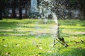 Abstract blurred of water from automatic sprinkler watering green grass Royalty Free Stock Photo