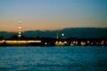 Abstract blurried lights over the city river background. Beautiful sunset over Neva river of St. Petersburg, Russia