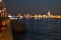 Abstract blurried lights over the night city river background. Beautiful sunset over Neva river of St. Petersburg, Russia