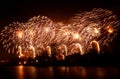 Abstract, blurry, bokeh-style colorful photo of fireworks above the river in New Year