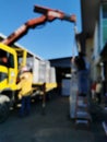 Abstract bokeh background of scenery lorry crane loading switchboard during sunny day. Royalty Free Stock Photo