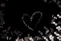 Abstract bokeh background shape heart on black background, love Valentine Day, for copy text card, white light dot background Royalty Free Stock Photo