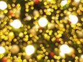 abstract bokeh blur light circle red orange and golden christmas tree glowing flare pattern black background Royalty Free Stock Photo