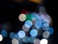 Abstract bokeh night light background, blurred lights traces from cars on road, defocused city traffic on street at night Royalty Free Stock Photo