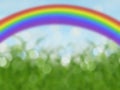 Abstract bokeh rainbow background with blue sky and grass