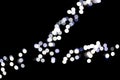 Abstract bokeh of white city lights on black background. defocused and blurred many round light Royalty Free Stock Photo