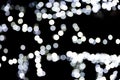 Abstract bokeh of white city lights on black background. defocused and blurred many round light Royalty Free Stock Photo