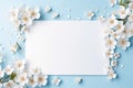 Abstract branches with white flowers around white paper card on blue background