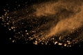 Abstract brown powder splatted background. Colorful powder explosion on black background. Colored cloud. Colorful dust explode. Royalty Free Stock Photo