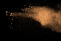 Abstract brown powder splatted background. Colorful powder explosion on black background. Colored cloud. Colorful dust explode. Pa Royalty Free Stock Photo