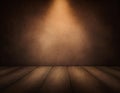 Brown vignette background with brighter center and light coming down from above on the wood floor Royalty Free Stock Photo