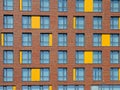 Abstract brown and yellow brick facade with windows Royalty Free Stock Photo